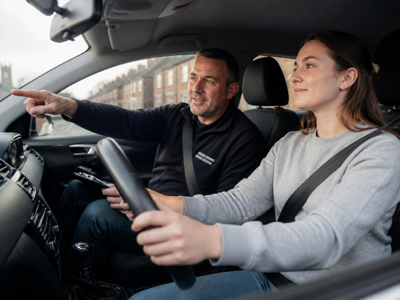 Friendly driving instructor teaching a learner driver in Preston